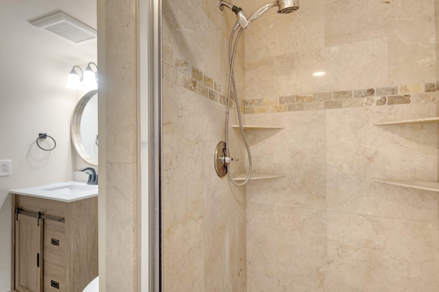 full bathroom with visible vents, a shower stall, and vanity