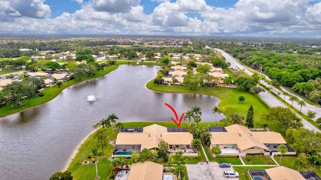 birds eye view of property with a water view and a residential view