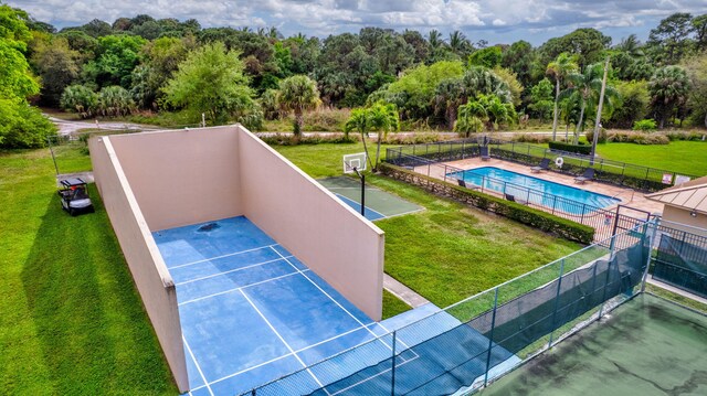 view of basketball court with community basketball court and fence