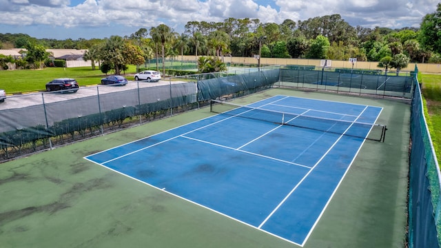 view of sport court featuring fence