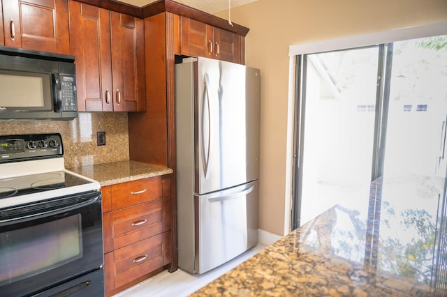 kitchen with tasteful backsplash, stone counters, brown cabinetry, and black appliances