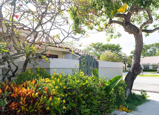 view of side of property featuring fence and stucco siding