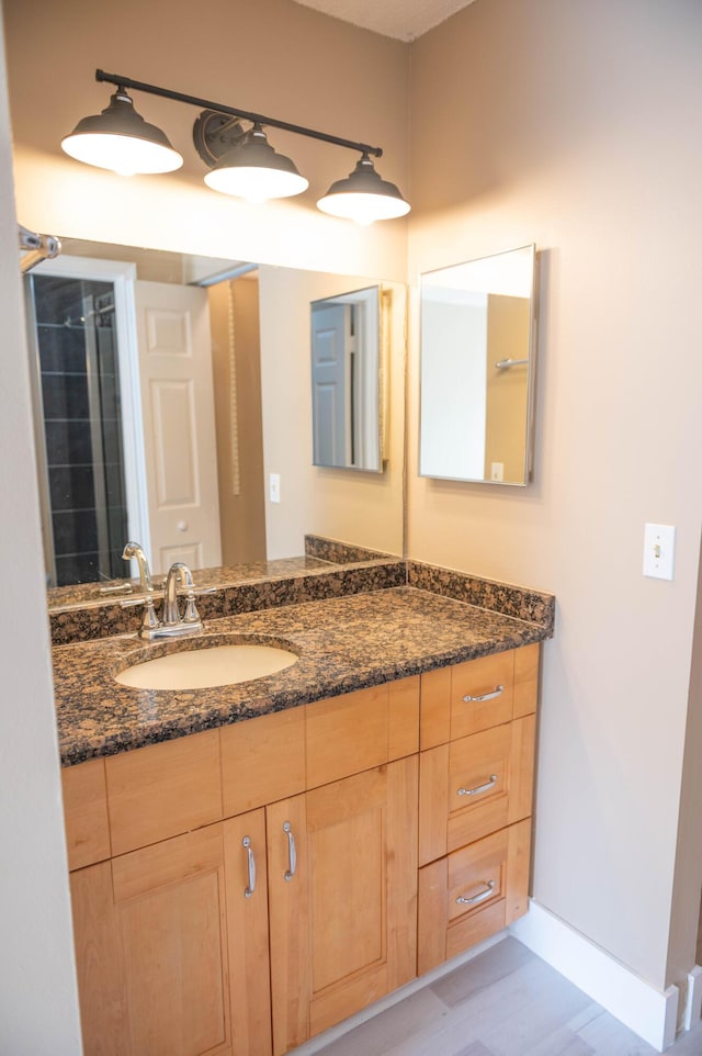 bathroom with baseboards and vanity