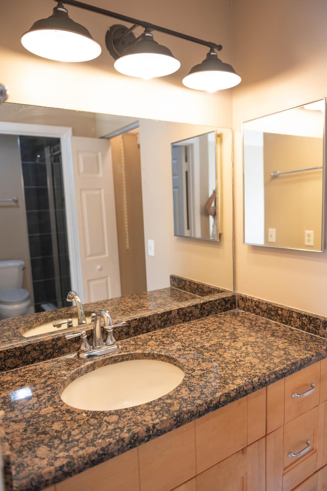 bathroom featuring vanity and toilet