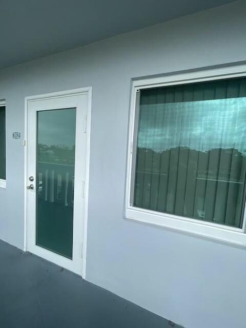 entrance to property with stucco siding