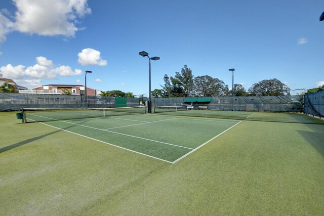 view of sport court featuring fence