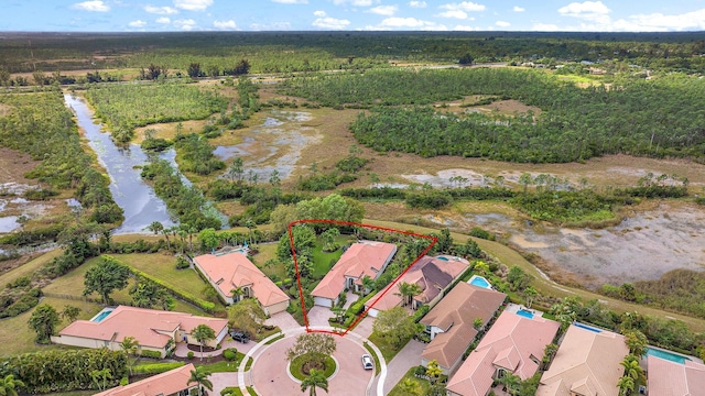 drone / aerial view featuring a residential view and a water view