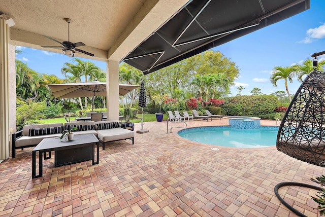 view of swimming pool with a pool with connected hot tub, an outdoor living space, a ceiling fan, and a patio