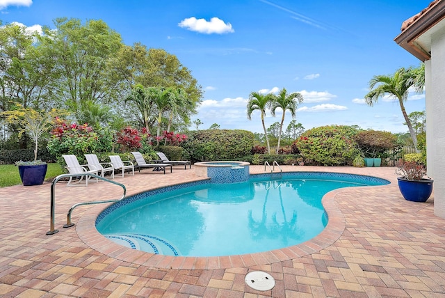 view of pool with a pool with connected hot tub and a patio area