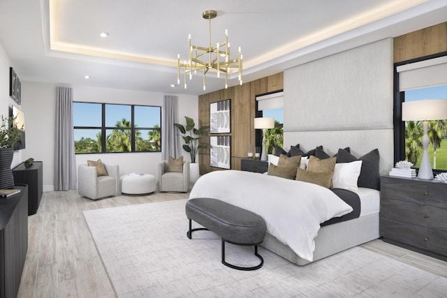 bedroom with a tray ceiling, light wood-type flooring, recessed lighting, and an inviting chandelier