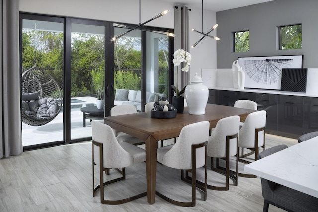 dining room with floor to ceiling windows and light wood-style flooring