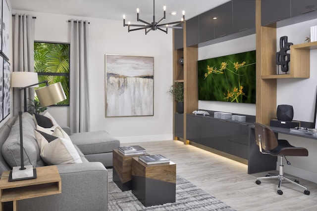 home office featuring baseboards, light wood finished floors, and a notable chandelier