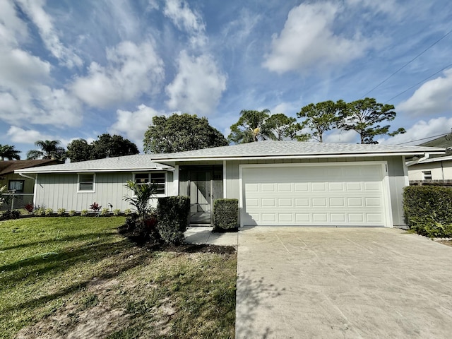 single story home featuring driveway, a garage, and a front lawn