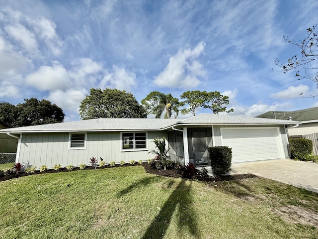 ranch-style home featuring an attached garage, driveway, a front lawn, and fence