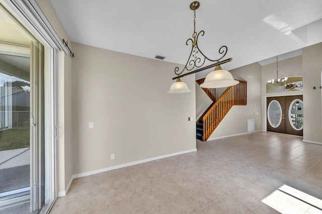 interior space featuring an inviting chandelier, visible vents, baseboards, and stairs