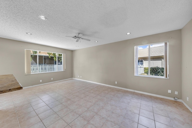 unfurnished room featuring recessed lighting, a healthy amount of sunlight, ceiling fan, and baseboards