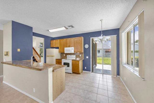 kitchen with white appliances, light tile patterned floors, visible vents, decorative backsplash, and a chandelier