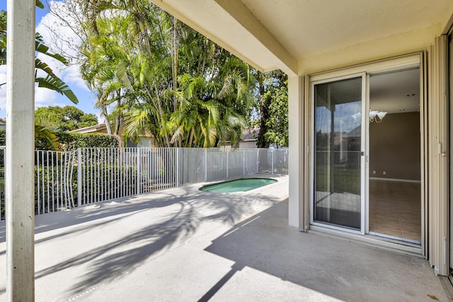 view of patio / terrace with a jacuzzi and fence