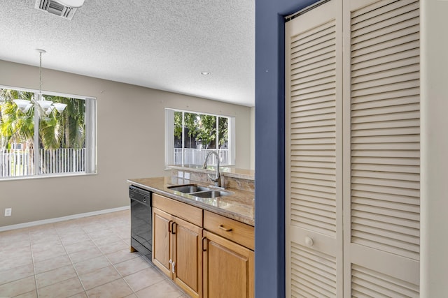 kitchen featuring visible vents, light tile patterned flooring, a sink, a textured ceiling, and dishwasher