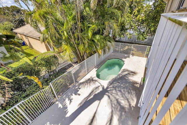 view of swimming pool with a hot tub, fence, and a patio