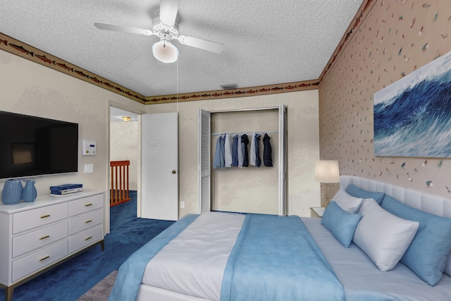 carpeted bedroom with wallpapered walls, visible vents, a ceiling fan, a textured ceiling, and a closet