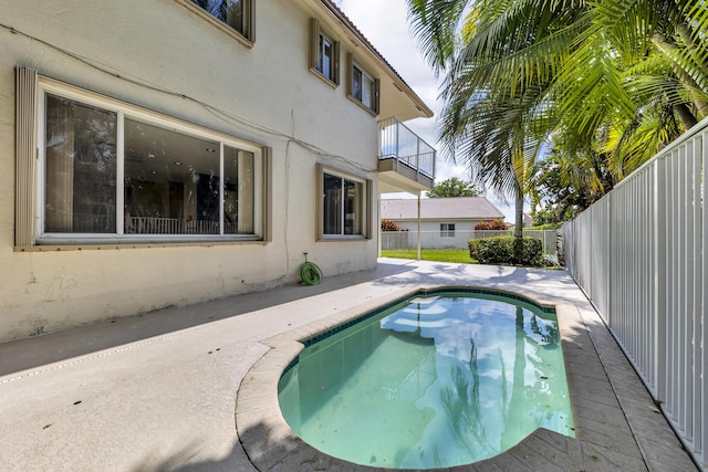 view of swimming pool with a patio area, a fenced backyard, and a fenced in pool