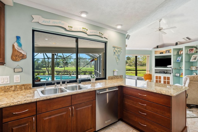 kitchen with light stone counters, open floor plan, a textured ceiling, stainless steel dishwasher, and a sink