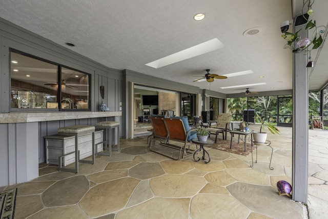 view of patio featuring ceiling fan