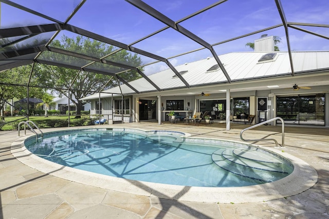 outdoor pool featuring a patio area, ceiling fan, and glass enclosure