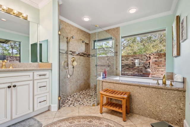 full bathroom featuring ornamental molding, a stall shower, vanity, a bath, and tile patterned floors