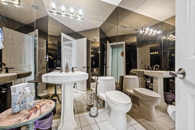 bathroom featuring a sink, toilet, and tile patterned floors