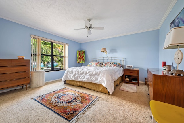 carpeted bedroom with crown molding, a textured ceiling, and baseboards