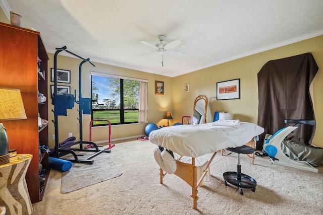 carpeted bedroom with ceiling fan, ornamental molding, and baseboards