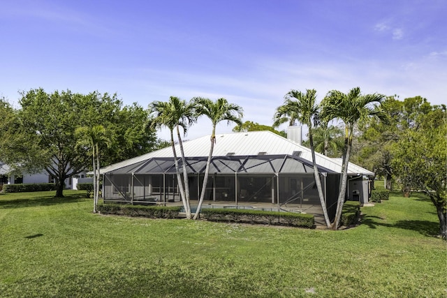 back of house featuring a yard and a lanai