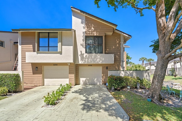 view of front of home featuring a garage and decorative driveway