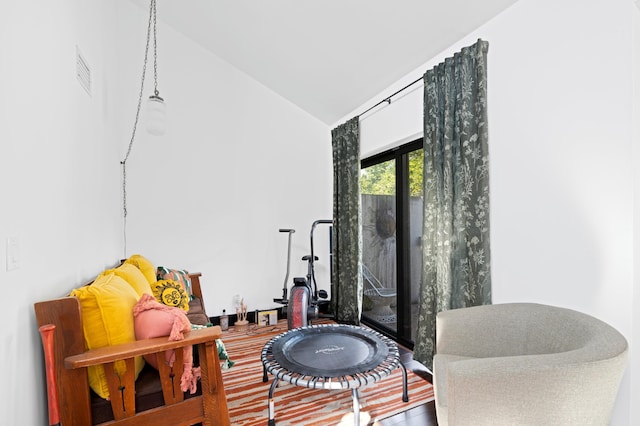 sitting room with lofted ceiling and visible vents