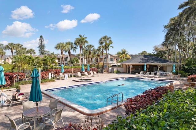 community pool featuring a patio area and fence