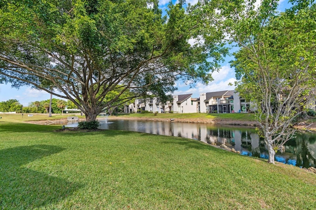 view of yard featuring a water view and a residential view