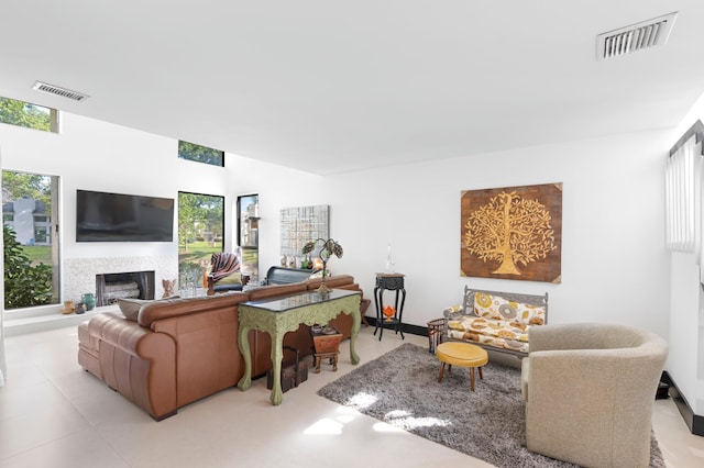 living area with a wealth of natural light, visible vents, and a fireplace