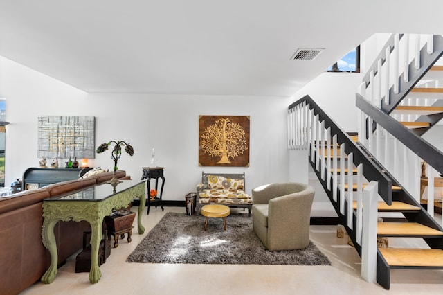 living area featuring stairway and visible vents