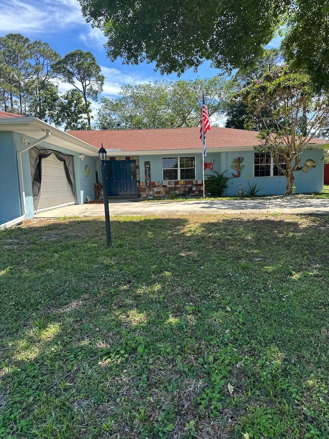 ranch-style house with stucco siding, driveway, an attached garage, and a front yard