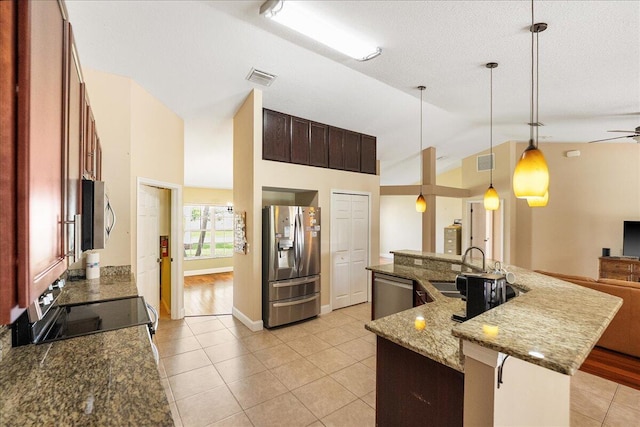 kitchen featuring appliances with stainless steel finishes, lofted ceiling, visible vents, and a sink