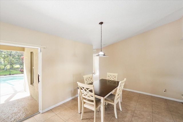 dining area featuring light tile patterned flooring and baseboards