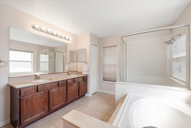 full bath with double vanity, tile patterned flooring, a shower stall, and a sink