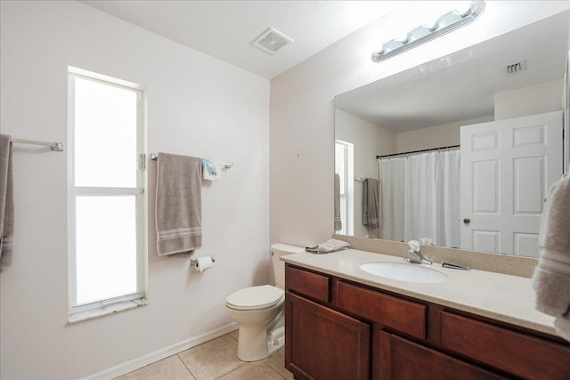 bathroom with toilet, vanity, visible vents, and tile patterned floors