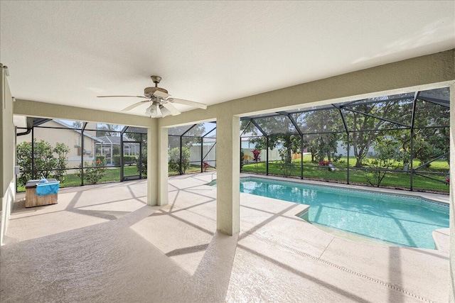 pool featuring a lanai, a patio area, and ceiling fan