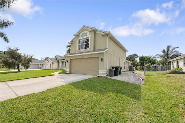 traditional home with an attached garage, a front lawn, concrete driveway, and stucco siding