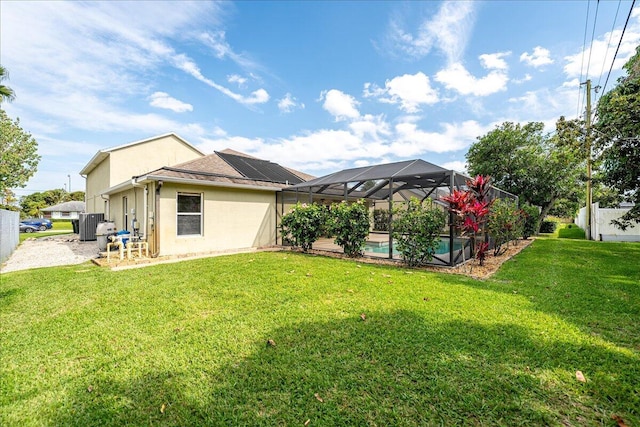 view of yard with glass enclosure and an outdoor pool