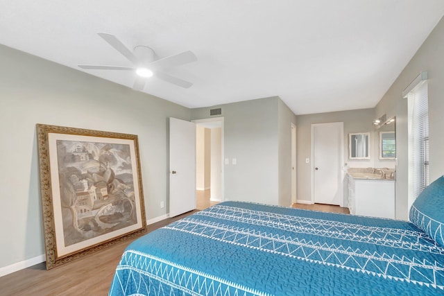 bedroom featuring visible vents, baseboards, a ceiling fan, and light wood finished floors