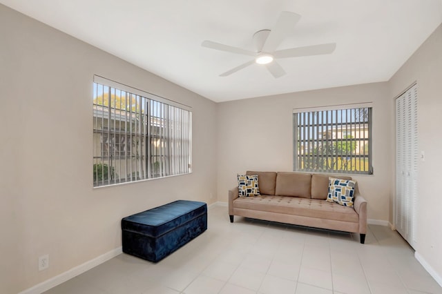 sitting room featuring baseboards, plenty of natural light, and ceiling fan